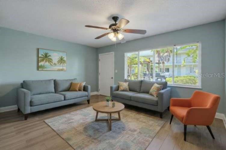 379 47th Avenue North, Unit 103 St. Petersburg, FL 33703 - Photo 7 of 24 a living room with furniture and a large window