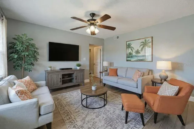 a living room with furniture and a flat screen tv