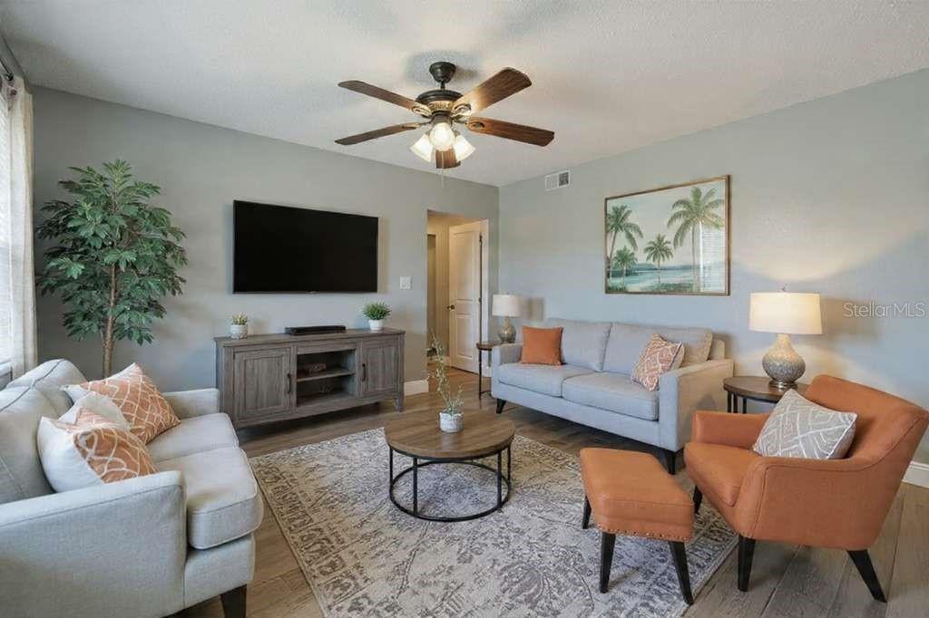 379 47th Avenue North, Unit 103 St. Petersburg, FL 33703 - Photo 10 of 24 a living room with furniture and a flat screen tv