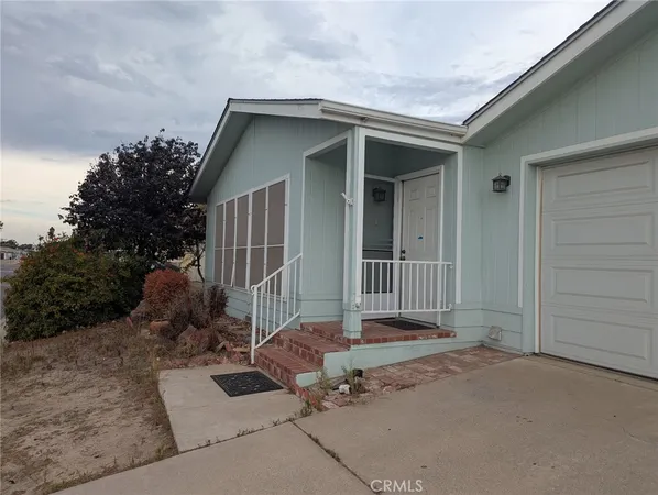 front view of a house with a bench