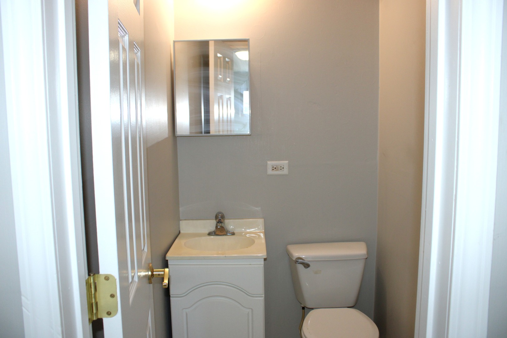 135 East Chestnut Street Coal City, IL 60416 - Photo 9 of 9 a bathroom with a toilet sink and mirror