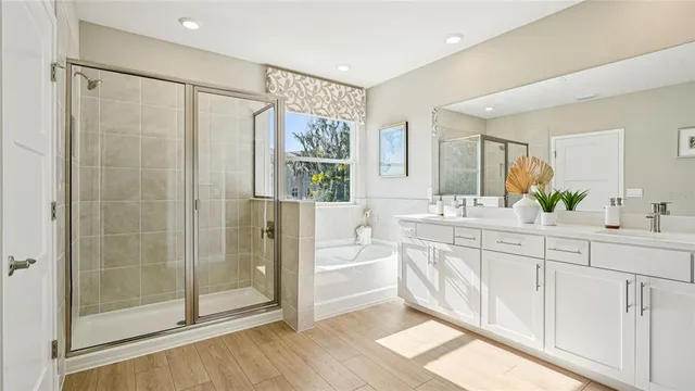 a spacious bathroom with a shower sink and mirror
