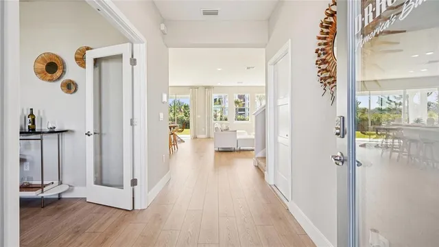 a view of a hallway with wooden floor and closet