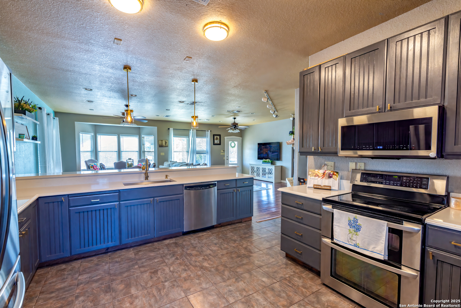 140 Twin Springs Road North Kerrville, TX 78028 - Photo 1 of 47 a kitchen with stainless steel appliances granite countertop a stove a sink and a microwave