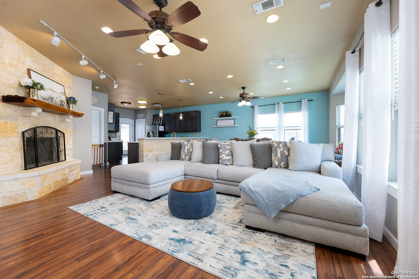 140 Twin Springs Road North Kerrville, TX 78028 - Photo 11 of 47 a living room with furniture and a chandelier