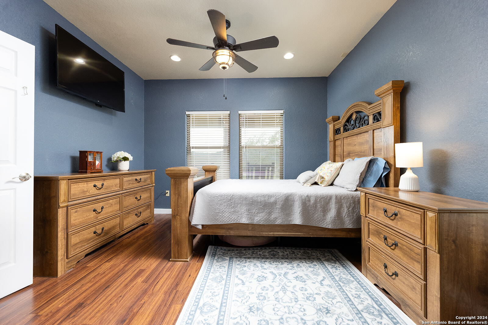 140 Twin Springs Road North Kerrville, TX 78028 - Photo 18 of 47 a bedroom with a bed and a flat tv screen on dresser