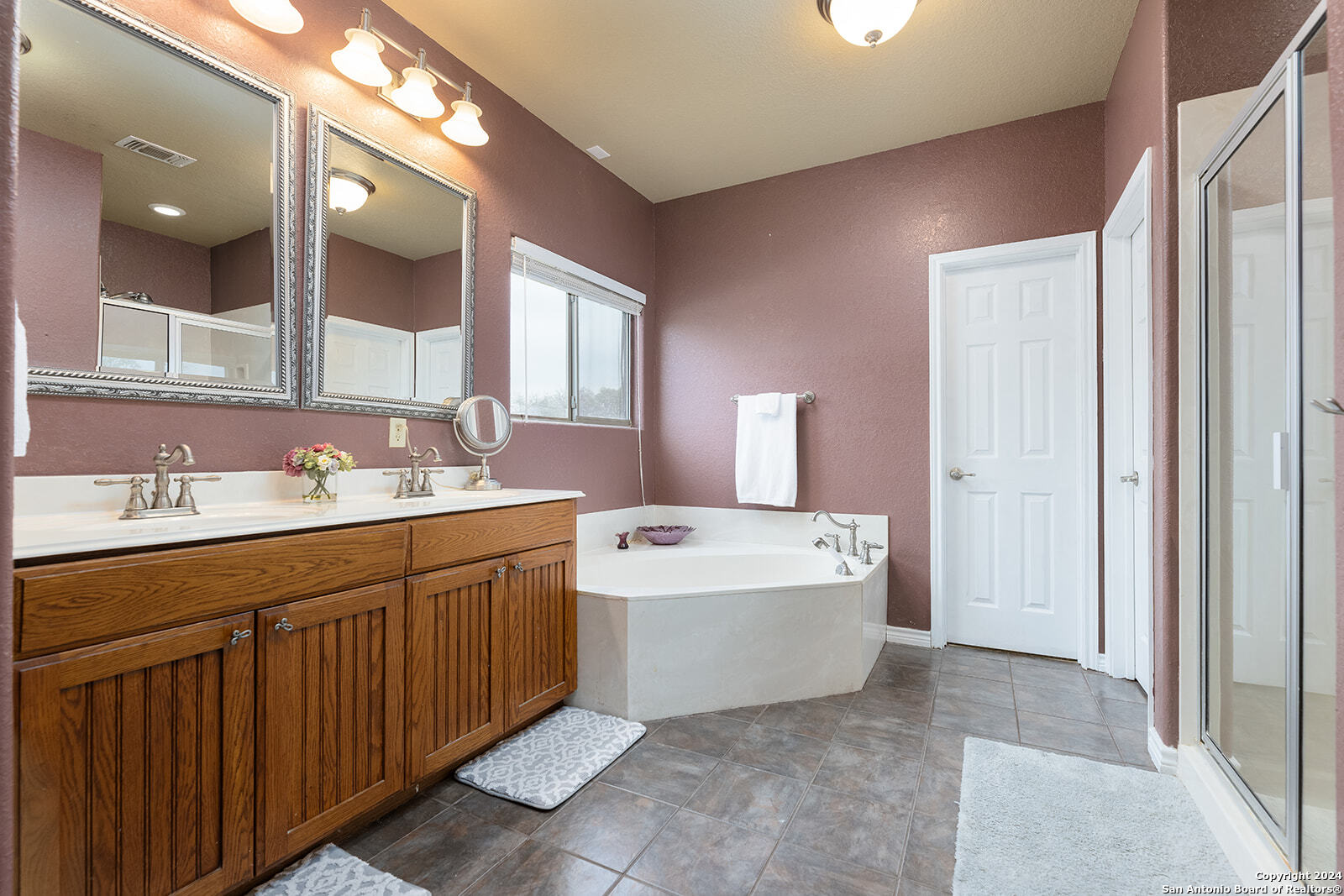 140 Twin Springs Road North Kerrville, TX 78028 - Photo 19 of 47 a spacious bathroom with a double vanity sink mirror and bathtub