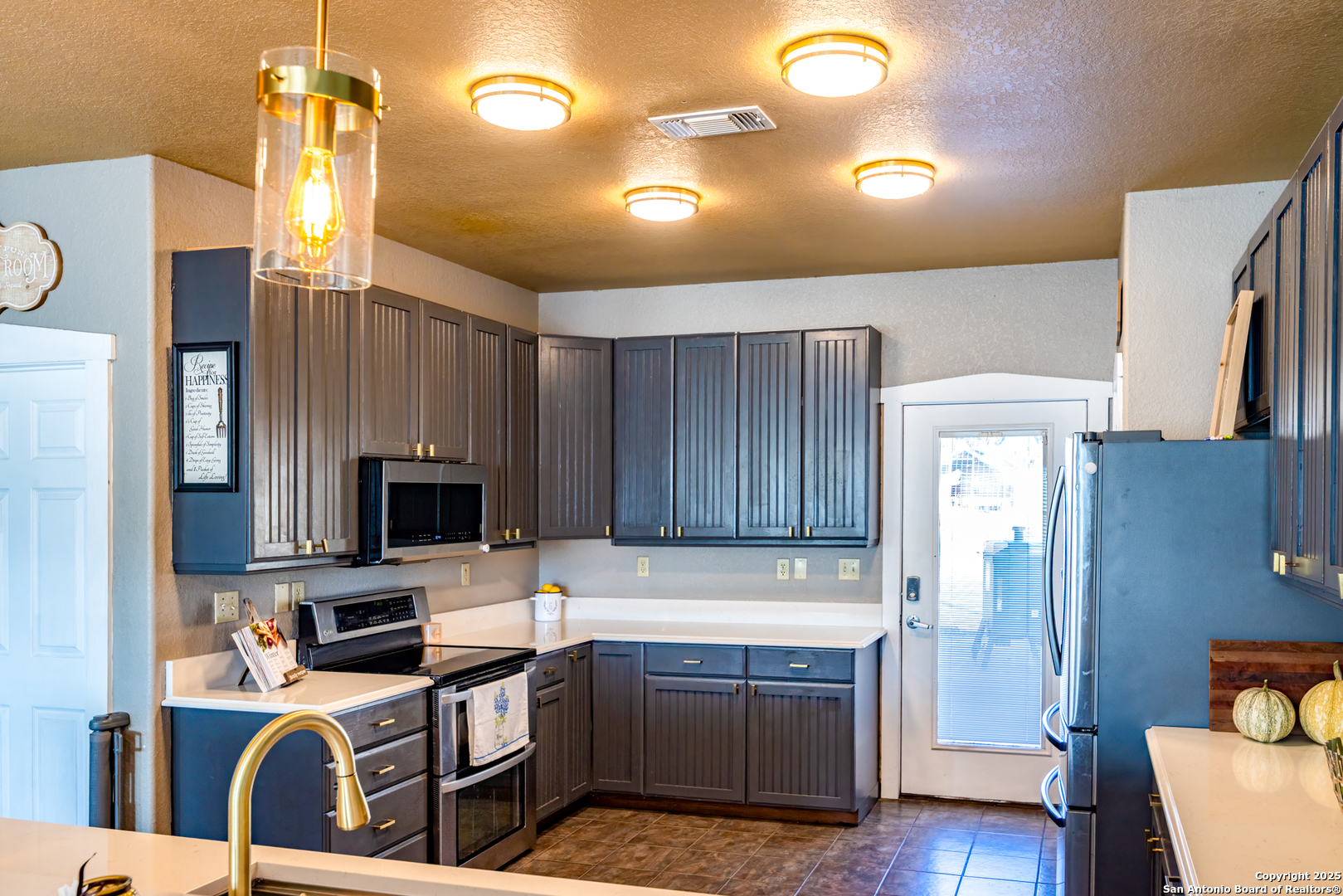 140 Twin Springs Road North Kerrville, TX 78028 - Photo 2 of 47 a kitchen with a refrigerator a stove top oven a sink and dishwasher