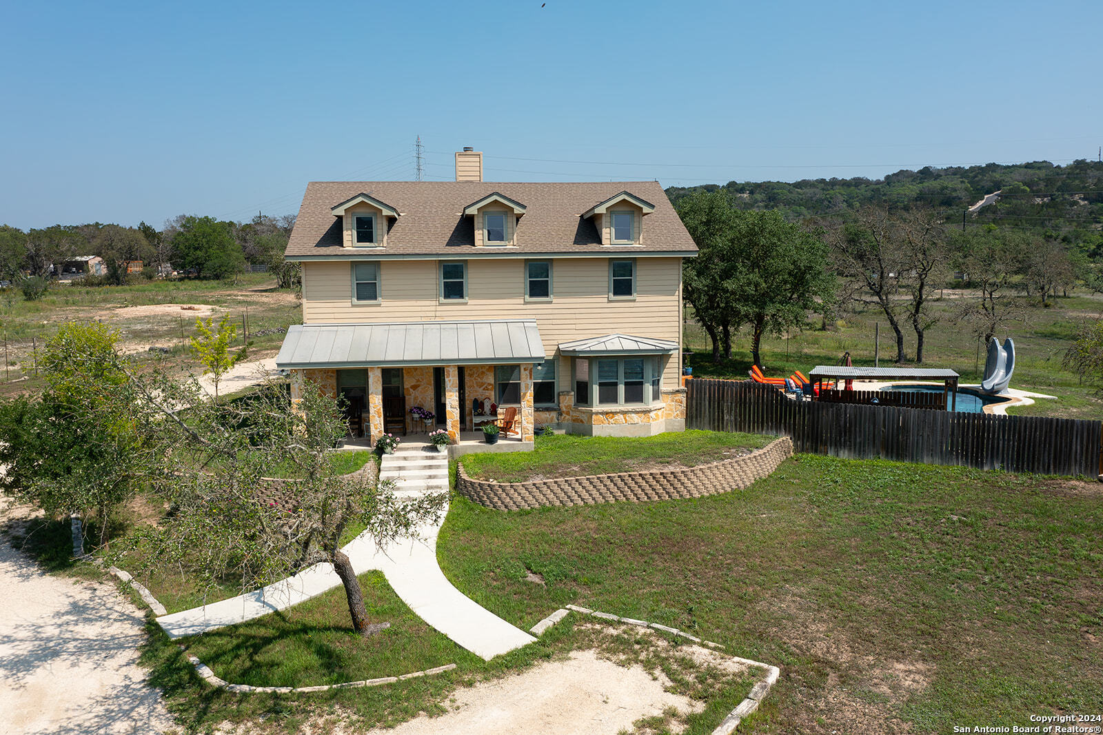 140 Twin Springs Road North Kerrville, TX 78028 - Photo 25 of 47 a view of a house with a swimming pool