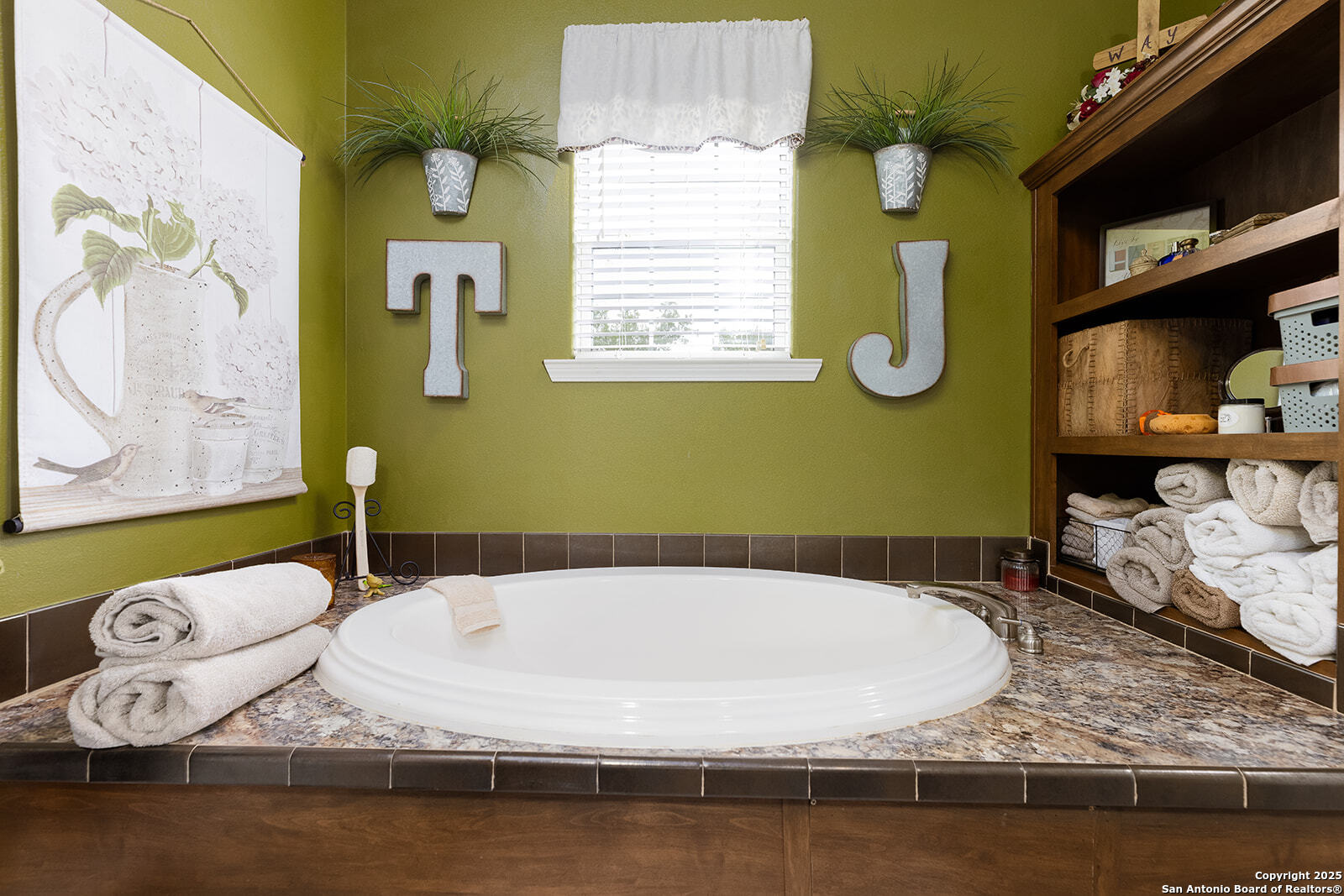 140 Twin Springs Road North Kerrville, TX 78028 - Photo 40 of 47 a bathroom with a granite countertop sink a mirror and a window