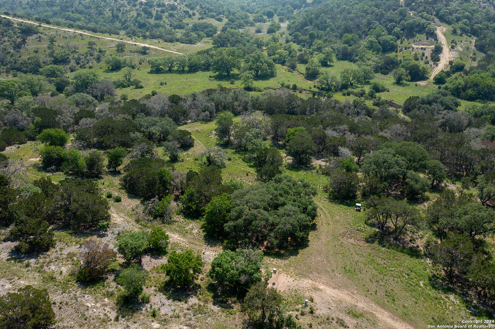 140 Twin Springs Road North Kerrville, TX 78028 - Photo 7 of 47 an aerial view of a forest with houses