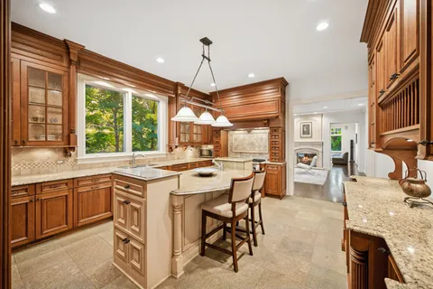 a dining room with furniture a chandelier and window