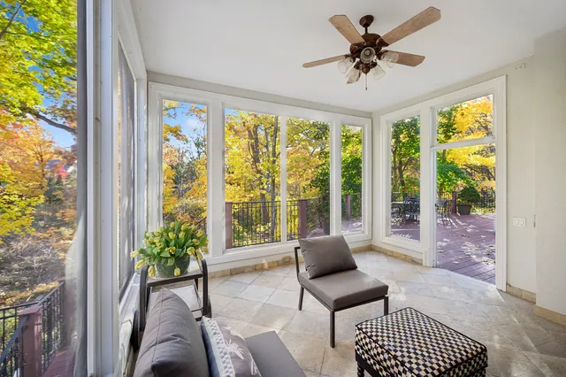 a living room with fireplace furniture and a large window