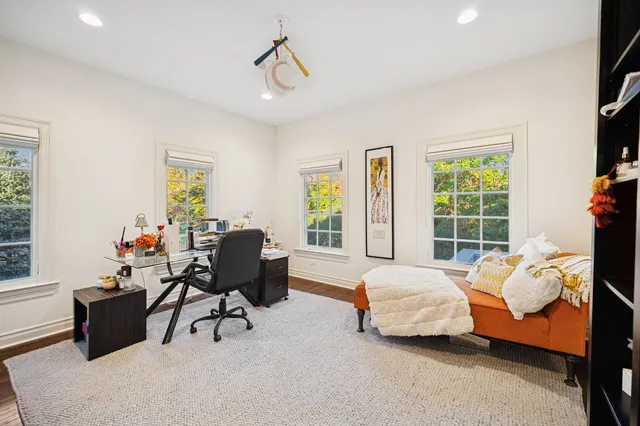 a bedroom with furniture and a large window