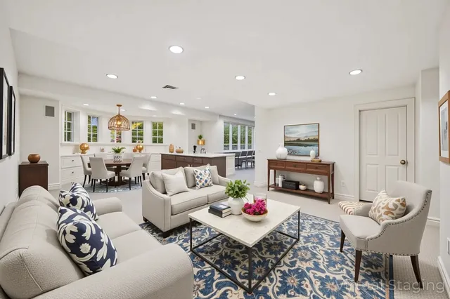 a living room with furniture chandelier and a table