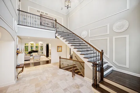 a bathroom with a toilet sink vanity granite and mirror