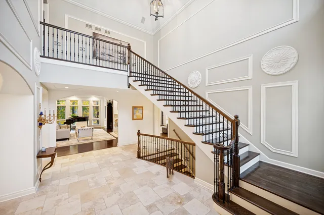 a bathroom with a toilet sink vanity granite and mirror