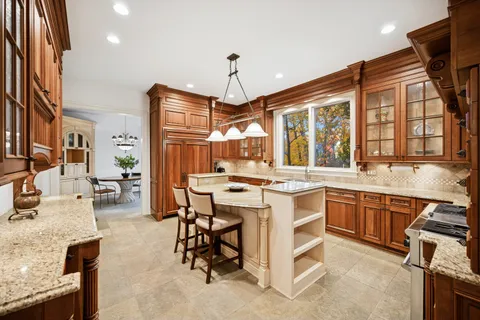 a open kitchen with stainless steel appliances granite countertop a stove and a sink