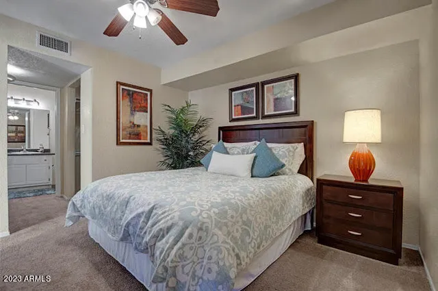 a bedroom with bed and a chandelier