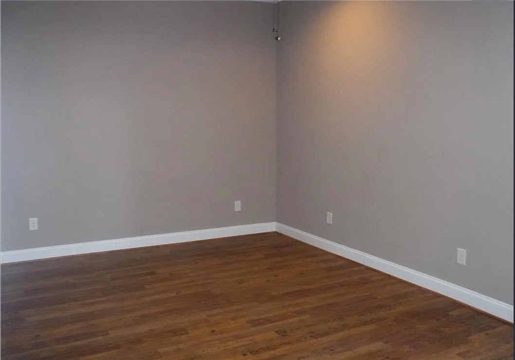 308 South Poplar Street Seneca, SC 29678 - Photo 2 of 9 This inviting room features warm wood flooring and a refreshing ceiling fan.
