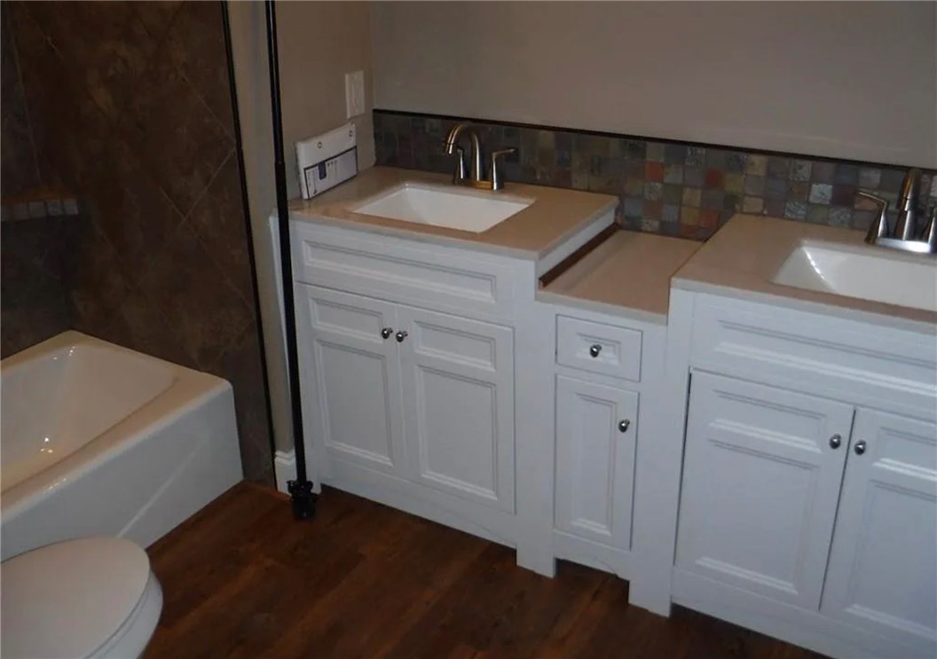 308 South Poplar Street Seneca, SC 29678 - Photo 4 of 9 This bathroom features dual vanities with elegant countertops and rich wood flooring.