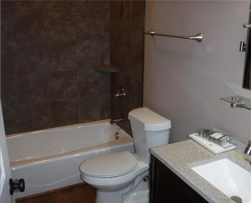 308 South Poplar Street Seneca, SC 29678 - Photo 6 of 9 This sleek bathroom features a modern vanity and tiled shower, offering a refreshing retreat.