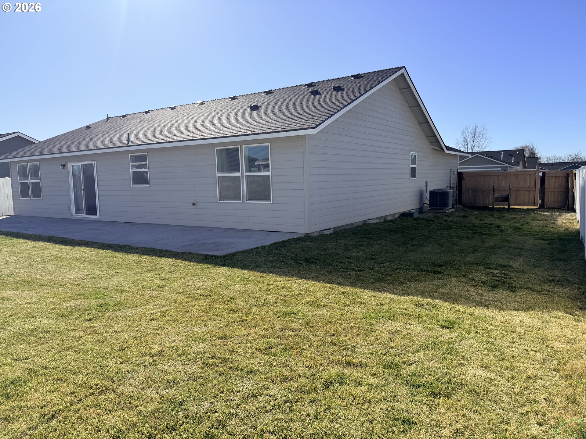 213 River Ridge Drive Boardman, OR 97818 - Photo 12 of 12 a view of a house with a backyard