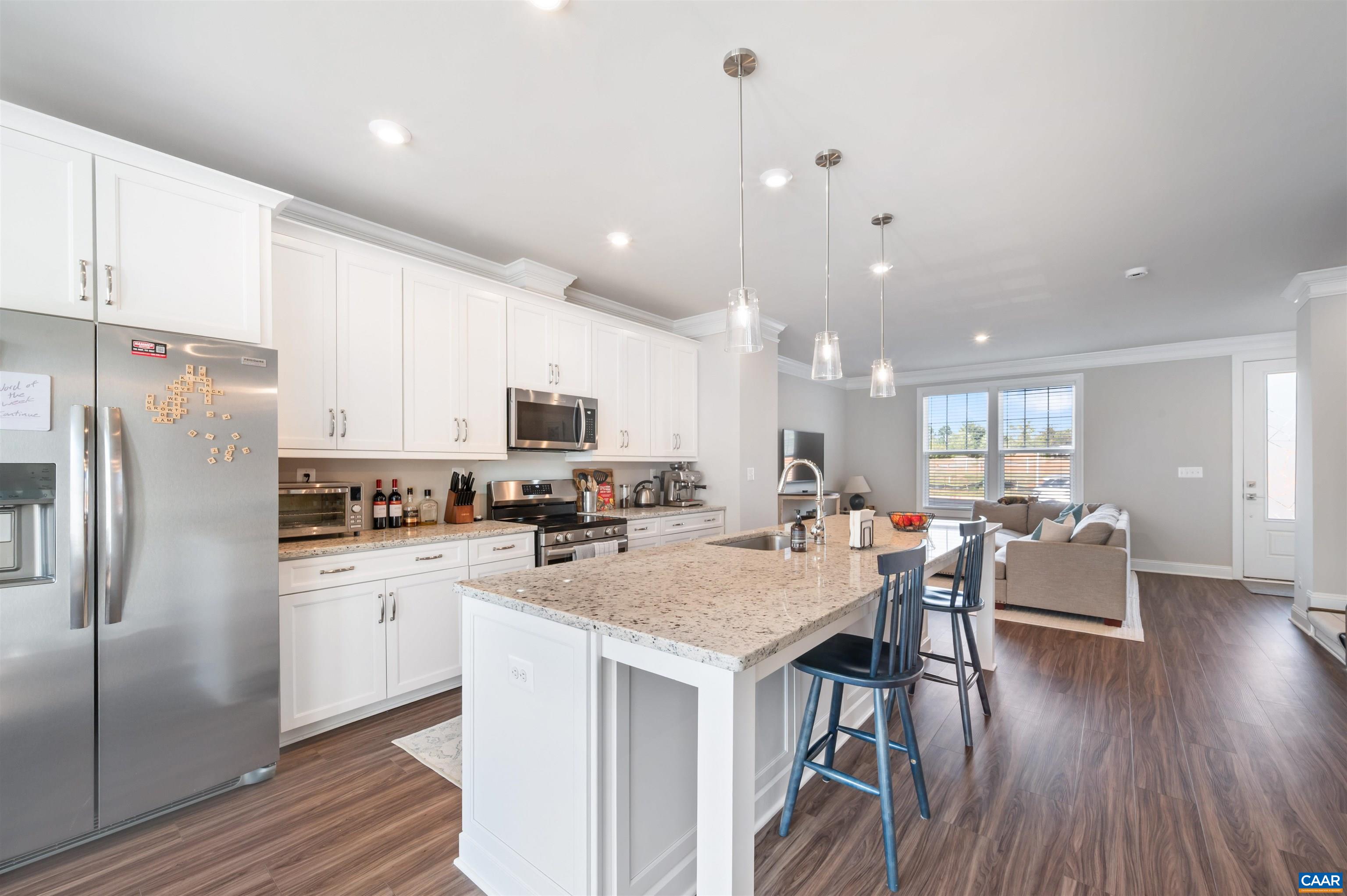 785 Park Ridge Drive Crozet, VA 22932 - Photo 16 of 50 a kitchen with stainless steel appliances granite countertop a refrigerator a stove top oven a sink dishwasher and white cabinets with wooden floor