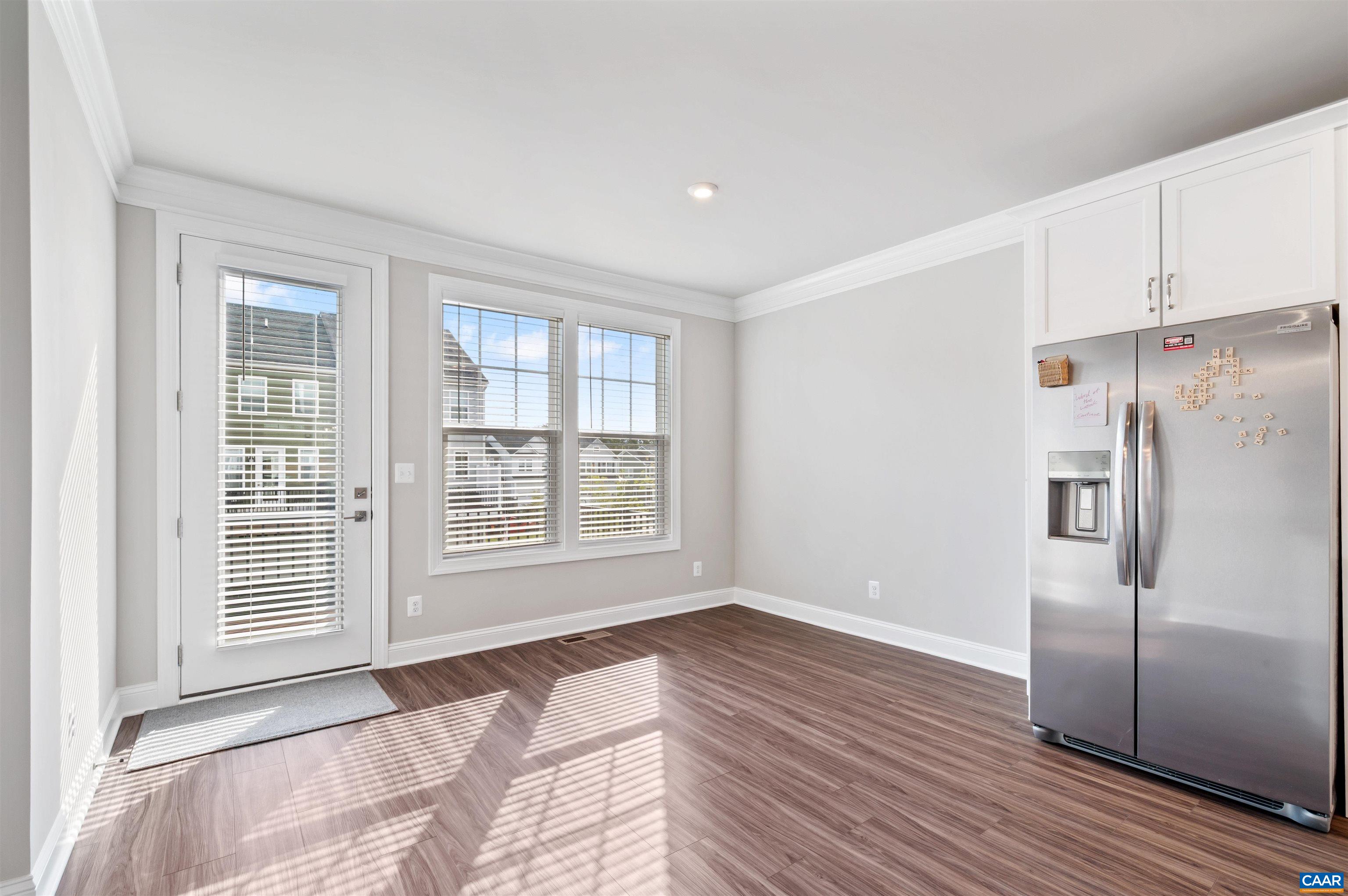 785 Park Ridge Drive Crozet, VA 22932 - Photo 17 of 50 a view of a kitchen with an empty room and wooden floor