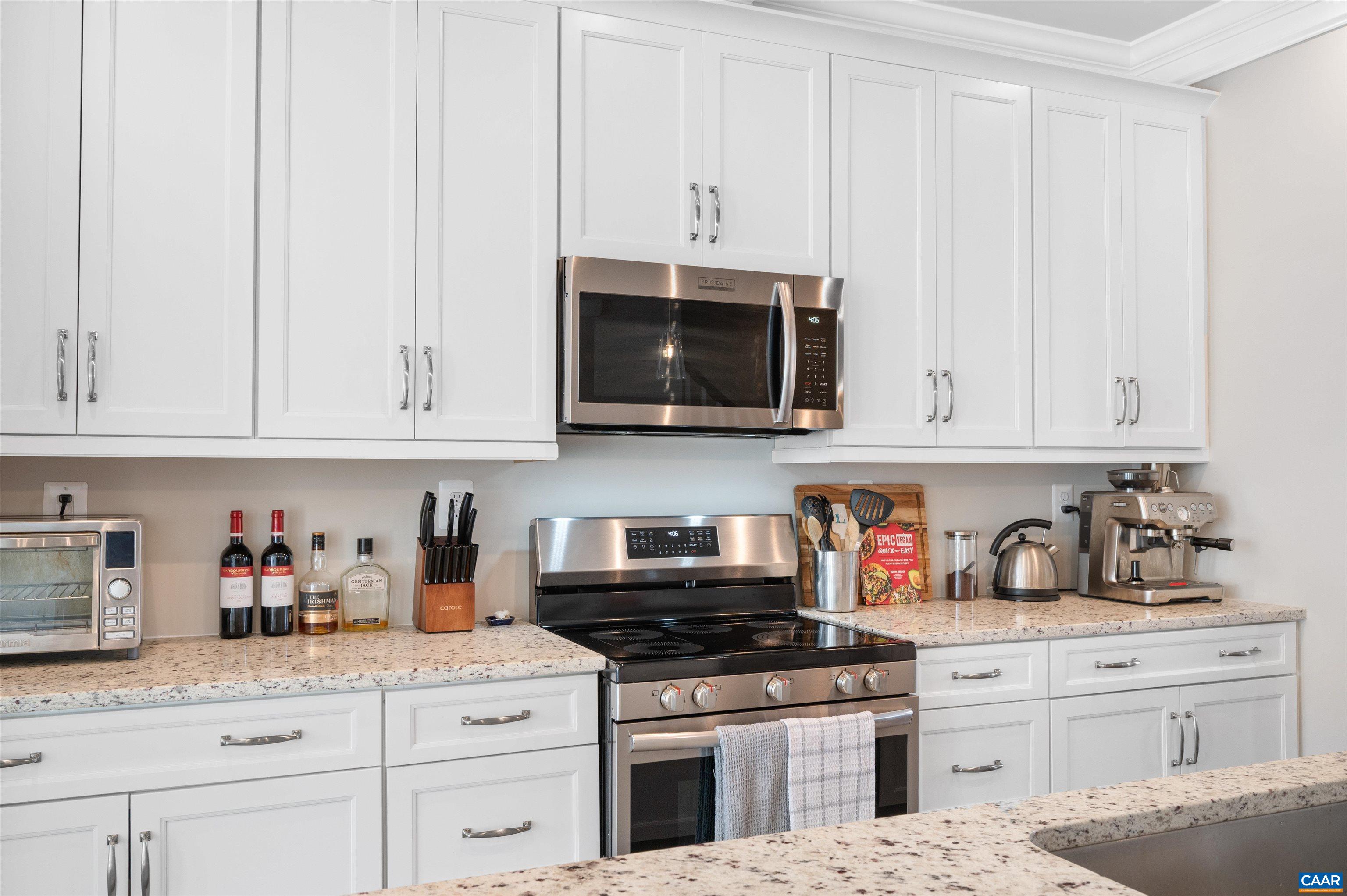 785 Park Ridge Drive Crozet, VA 22932 - Photo 20 of 50 a kitchen with granite countertop white cabinets and stainless steel appliances