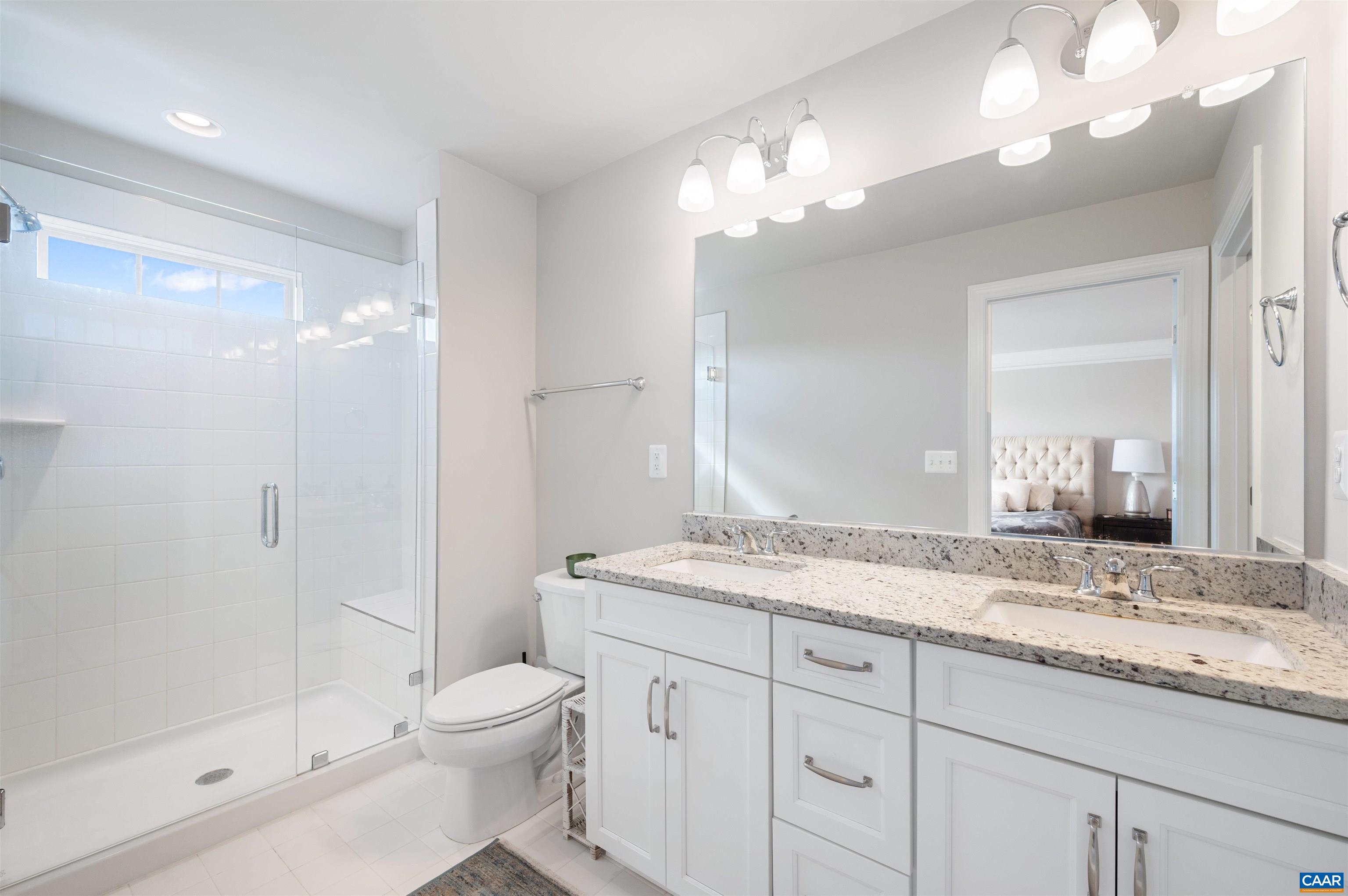 785 Park Ridge Drive Crozet, VA 22932 - Photo 27 of 50 a bathroom with a granite countertop sink a toilet and shower