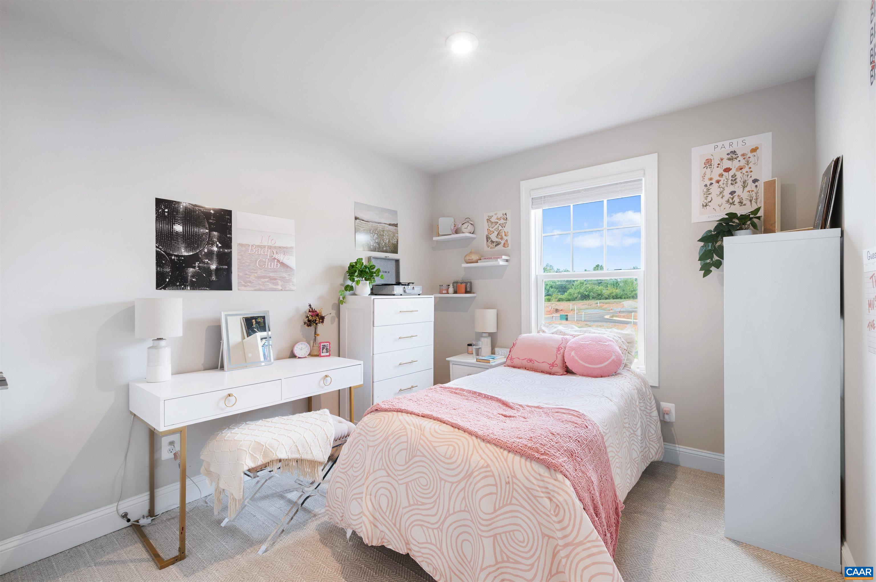 785 Park Ridge Drive Crozet, VA 22932 - Photo 34 of 50 a bedroom with a bed a table and a potted plant