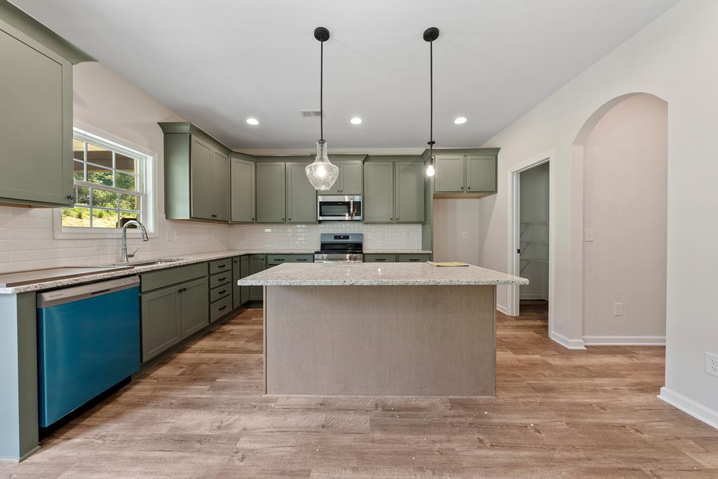 575 Bohannon Road Grantville, GA 30220 - Photo 12 of 33 a large kitchen with a large counter top space a sink appliances and cabinets