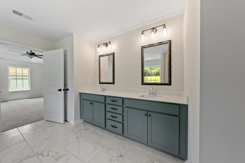 575 Bohannon Road Grantville, GA 30220 - Photo 29 of 33 a spacious bathroom with a double vanity sink mirror and wooden floor
