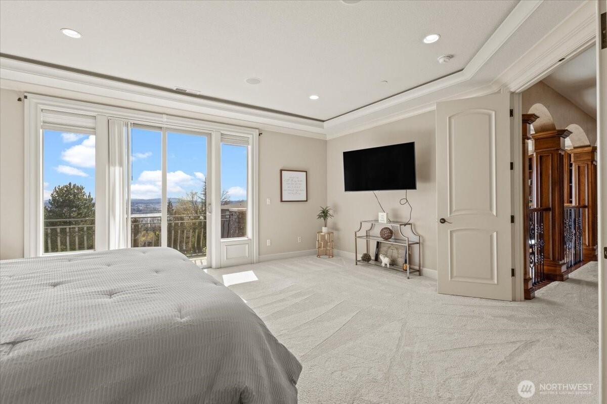 1931 Northwest 7th Avenue Camas, WA 98607 - Photo 28 of 40 a spacious bedroom with a bed and a flat screen tv