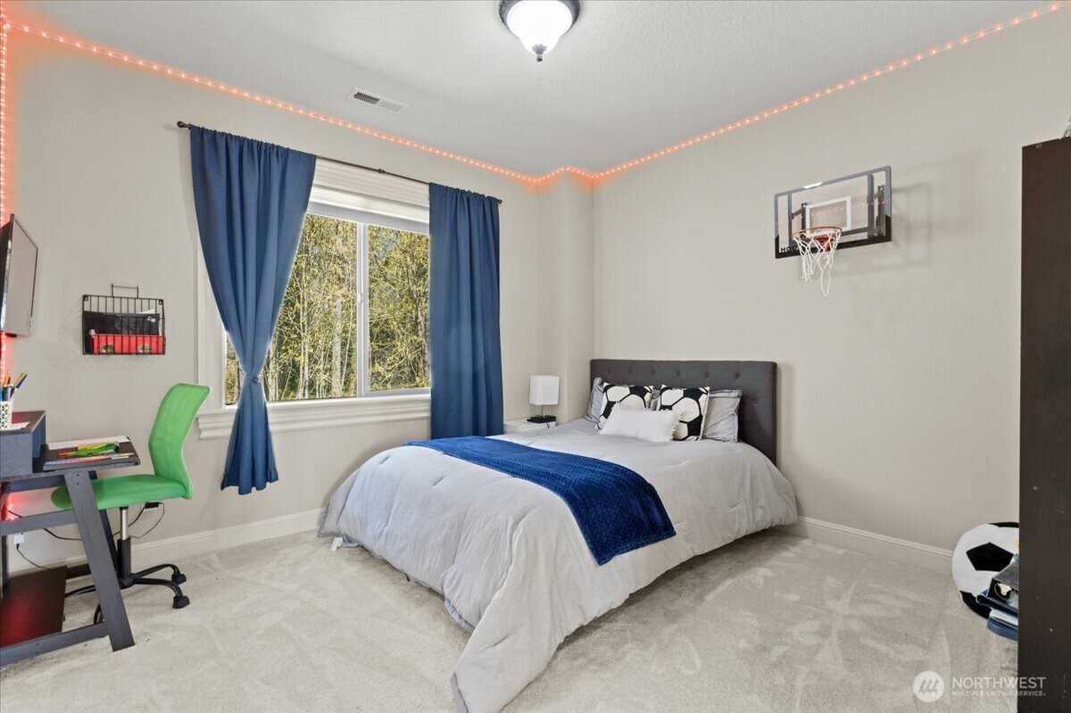 1931 Northwest 7th Avenue Camas, WA 98607 - Photo 32 of 40 a bedroom with a bed a large window and potted plant on the dresser