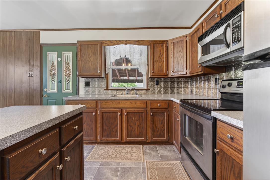 62 Stoney Road Tamaqua, PA 18252 - Photo 18 of 61 A functional kitchen boasts ample cabinetry, a generous island, and contemporary stainless steel appliances.