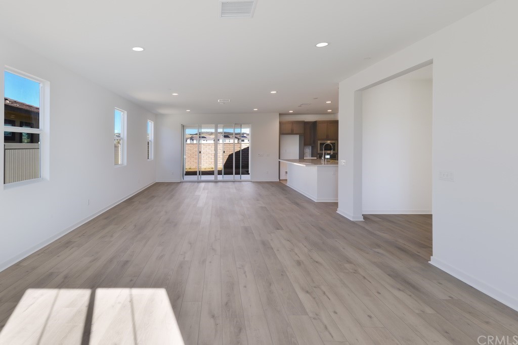 32324 Sonder Way Temecula, CA 92591 - Photo 2 of 17 a view of an empty room with wooden floor and a window