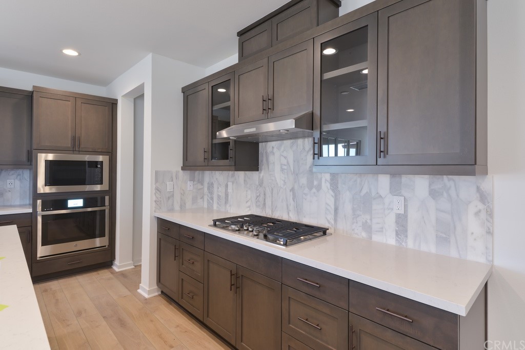 32324 Sonder Way Temecula, CA 92591 - Photo 3 of 17 a kitchen with stainless steel appliances a stove and a refrigerator