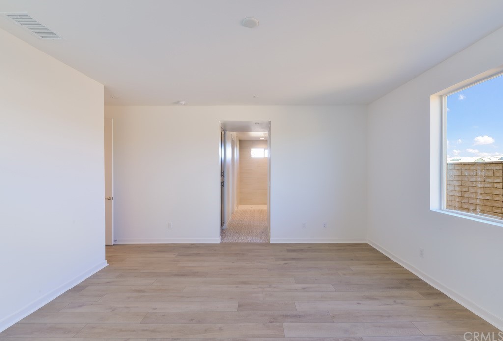 32324 Sonder Way Temecula, CA 92591 - Photo 8 of 17 an empty room with wooden floor and windows