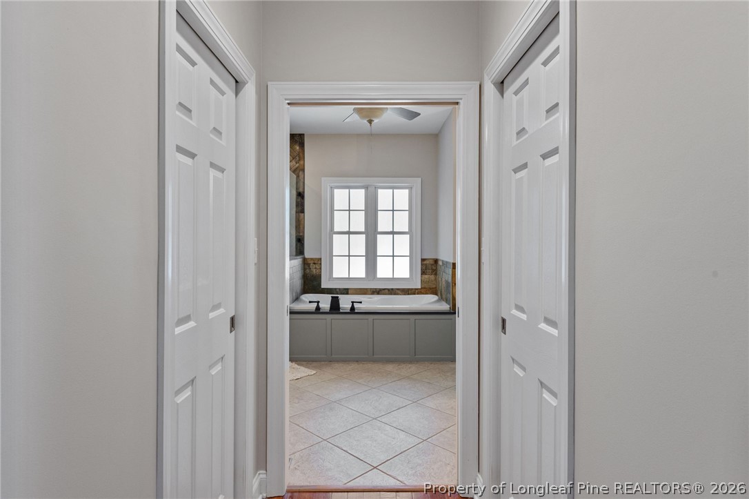 30180 East Lake Road Wagram, NC 28396 - Photo 26 of 42 a bathroom with a granite countertop tub and a sink