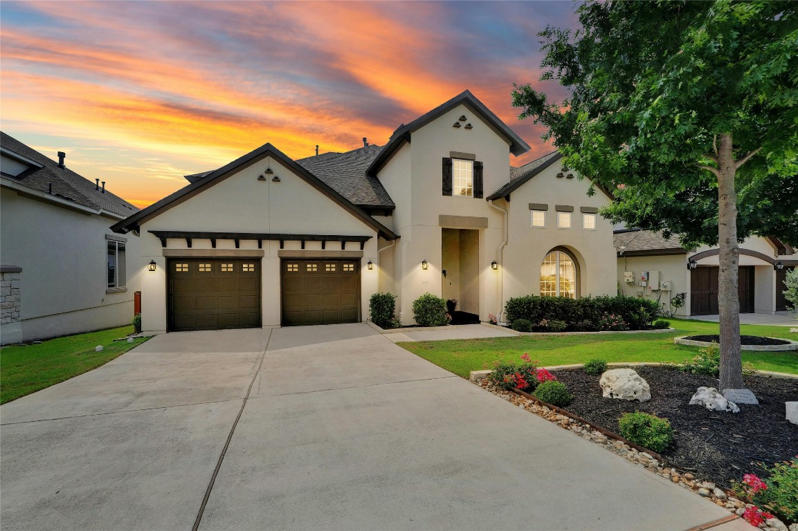 a front view of a house with a yard and garage