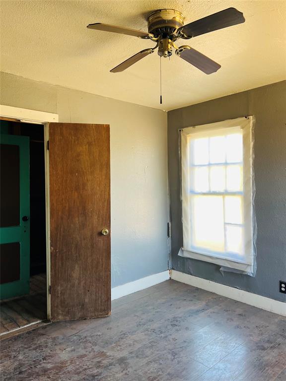 200 County Road 187 Comanche, TX 76442 - Photo 7 of 16 an empty room with windows and fan