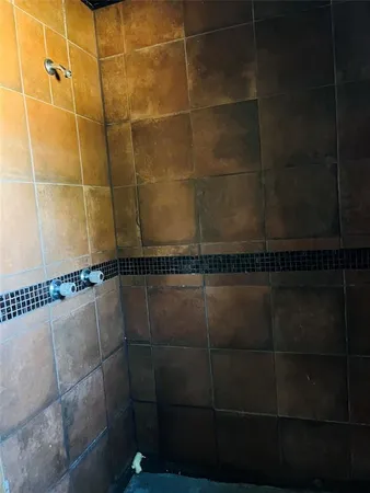 an empty room with wooden floor closet and entryway