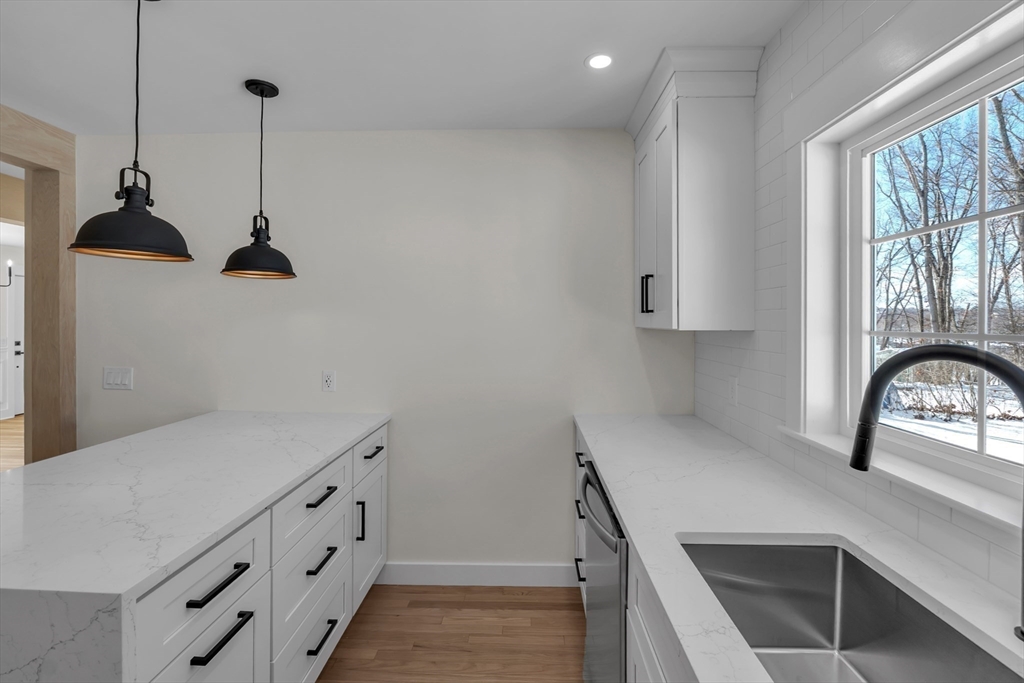 4 Hancock Street Shrewsbury, MA 01545 - Photo 13 of 33 a kitchen with white cabinets and window