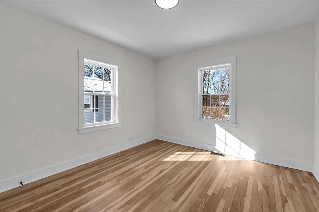 4 Hancock Street Shrewsbury, MA 01545 - Photo 19 of 33 an empty room with wooden floor and windows