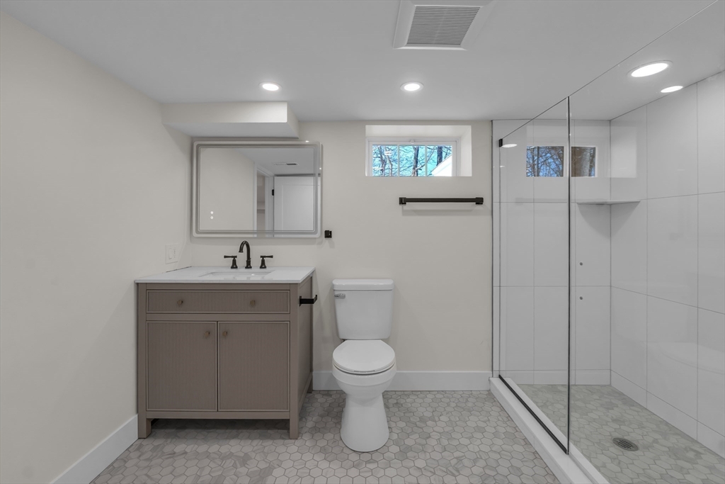 4 Hancock Street Shrewsbury, MA 01545 - Photo 25 of 33 a bathroom with a toilet sink and mirror