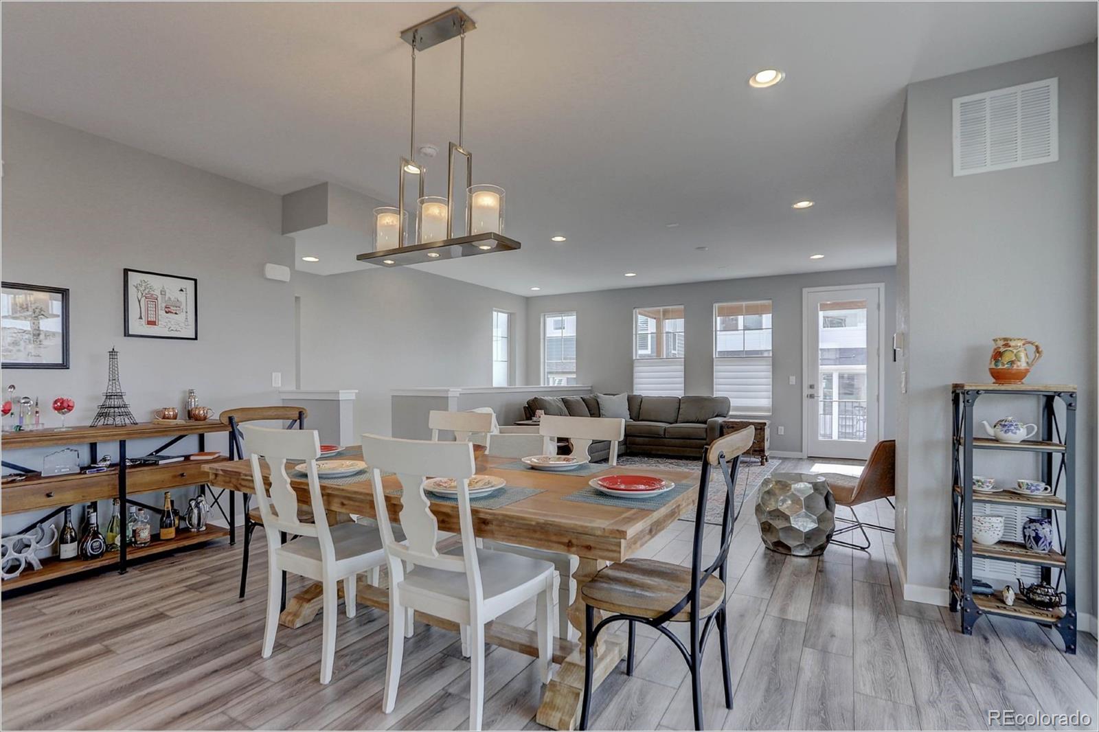 8928 Delacorte Street Highlands Ranch, CO 80129 - Photo 3 of 26 a view of a dining room with furniture and wooden floor