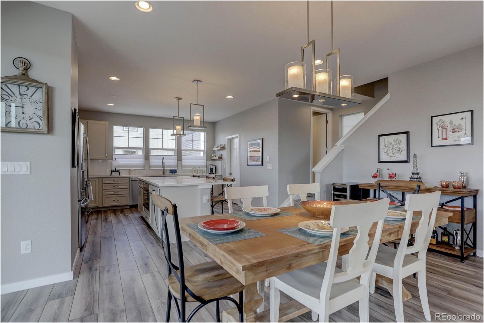 8928 Delacorte Street Highlands Ranch, CO 80129 - Photo 5 of 26 a view of a dining room with furniture and wooden floor