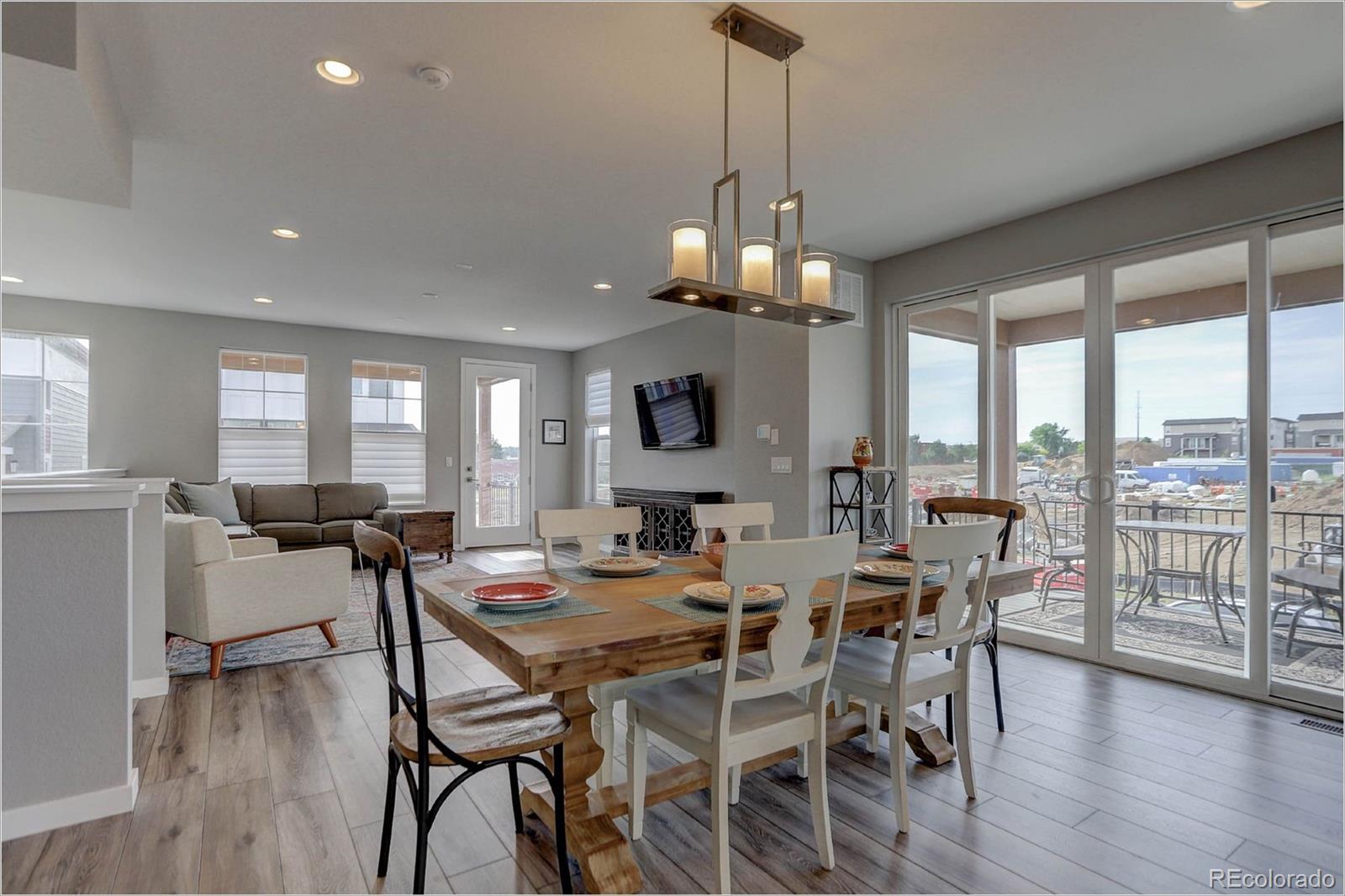 8928 Delacorte Street Highlands Ranch, CO 80129 - Photo 7 of 26 a view of a dining room with furniture window and wooden floor